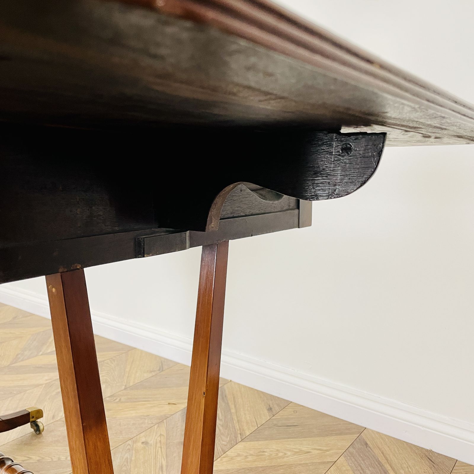 photo furniture Antique English Mahogany Drop Leaf Stretcher Table On Castors, 19th Century