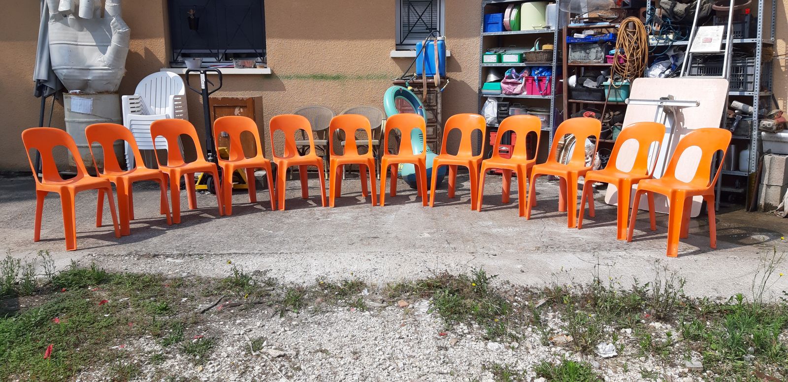 12 Stackable Orange Plastic Chairs