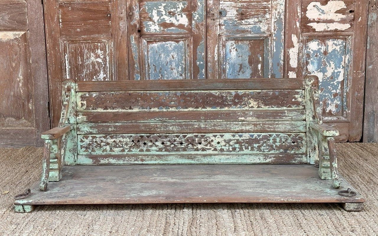 Decorative Teak Swing With Faded Green Paint Tones And Brass Chains