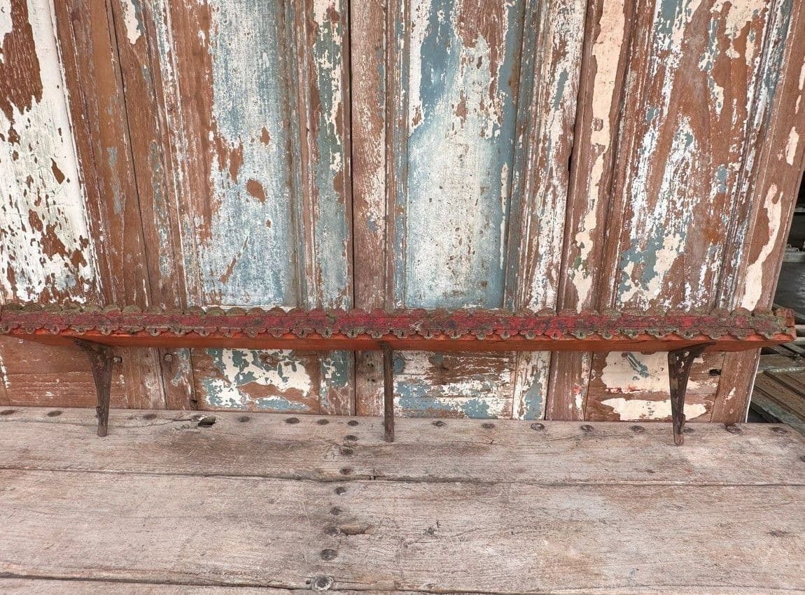 Antique Wooden Panel With Red Paint Tones Made Into A Shelf With Iron Brackets