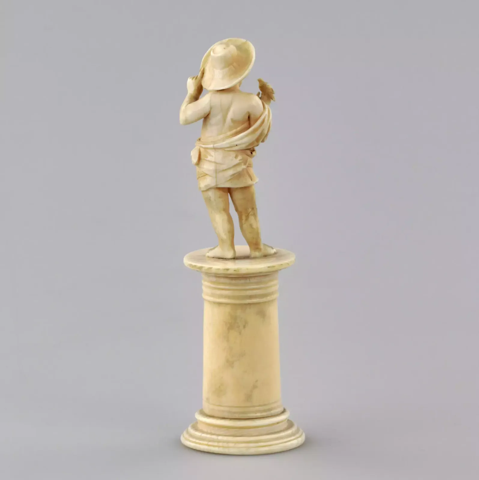 Carved Ivory Figurine Of A Boy With A Bird 1800s. photo vinterior
