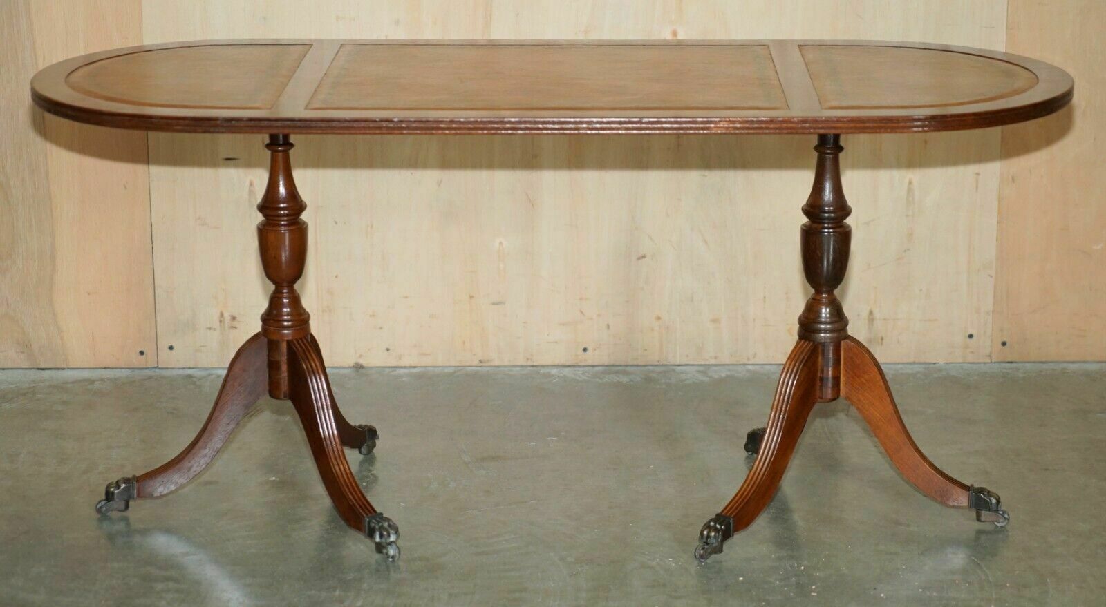 Vintage Hand Dyed And Aged Brown Leather Oval Coffee Table With Lion Castors photo for sale