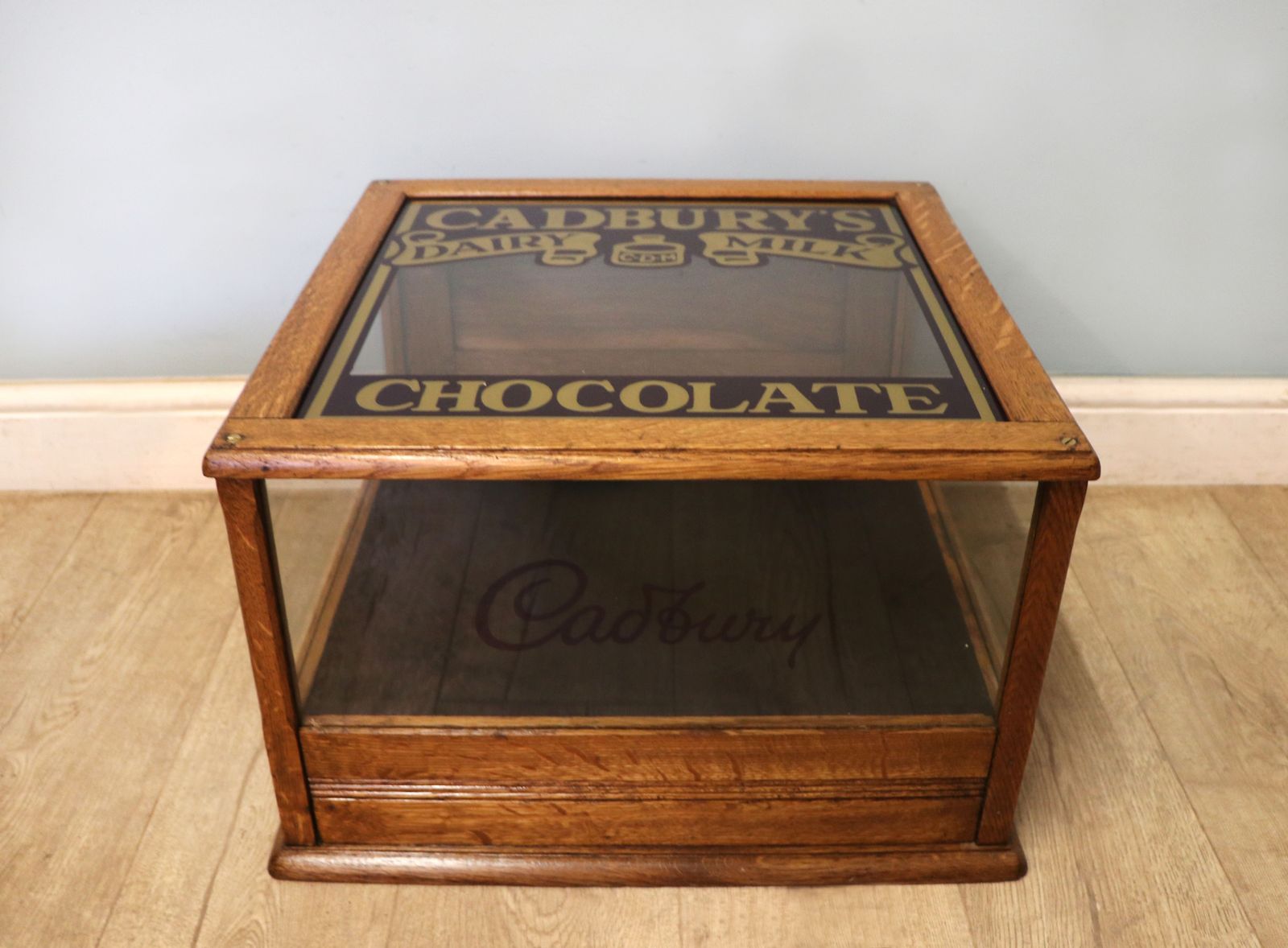 A Lovely Early 20th Century Oak Countertop Display Cabinet, Later Sign Written For Cadburys Chocolate. photo furniture