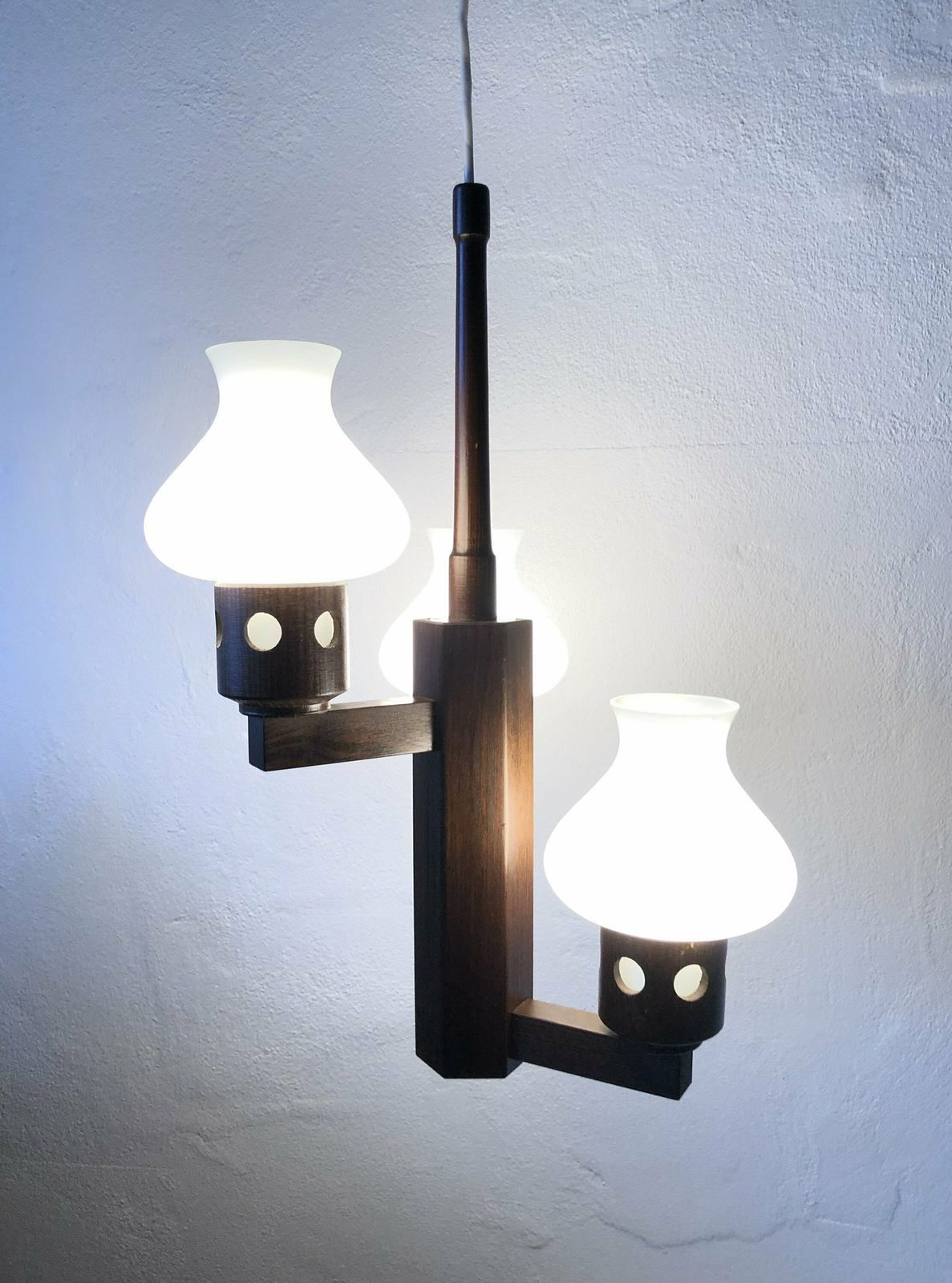 Mid Century Modern Three Armed Design Ceiling Lamp In Dark Toned Wood With Vintage White Glass Torch Shaped Shades photo for sale