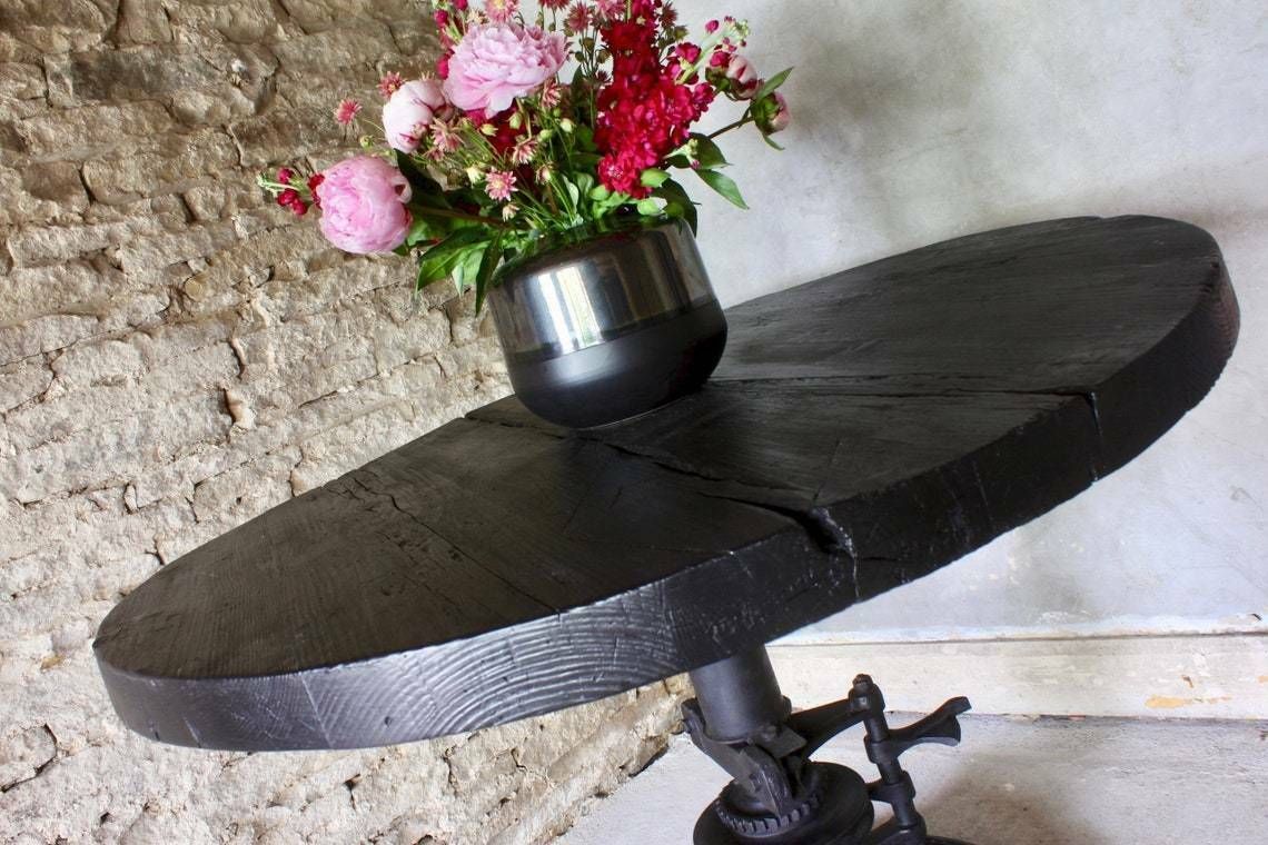 Shift Reclaimed Chunky Scorched Timber Circular Table With A Heavy Pedestal Base Made Out Of An Old Gear System photo for sale