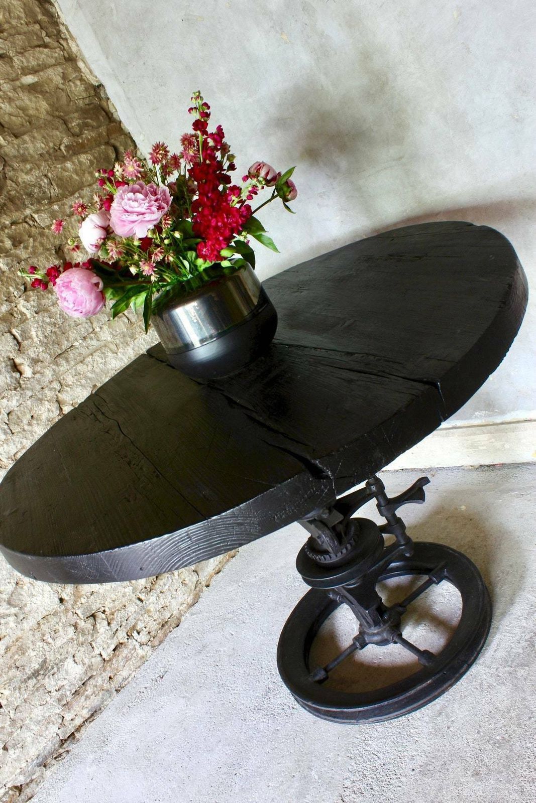 Shift Reclaimed Chunky Scorched Timber Circular Table With A Heavy Pedestal Base Made Out Of An Old Gear System photo 1795.0