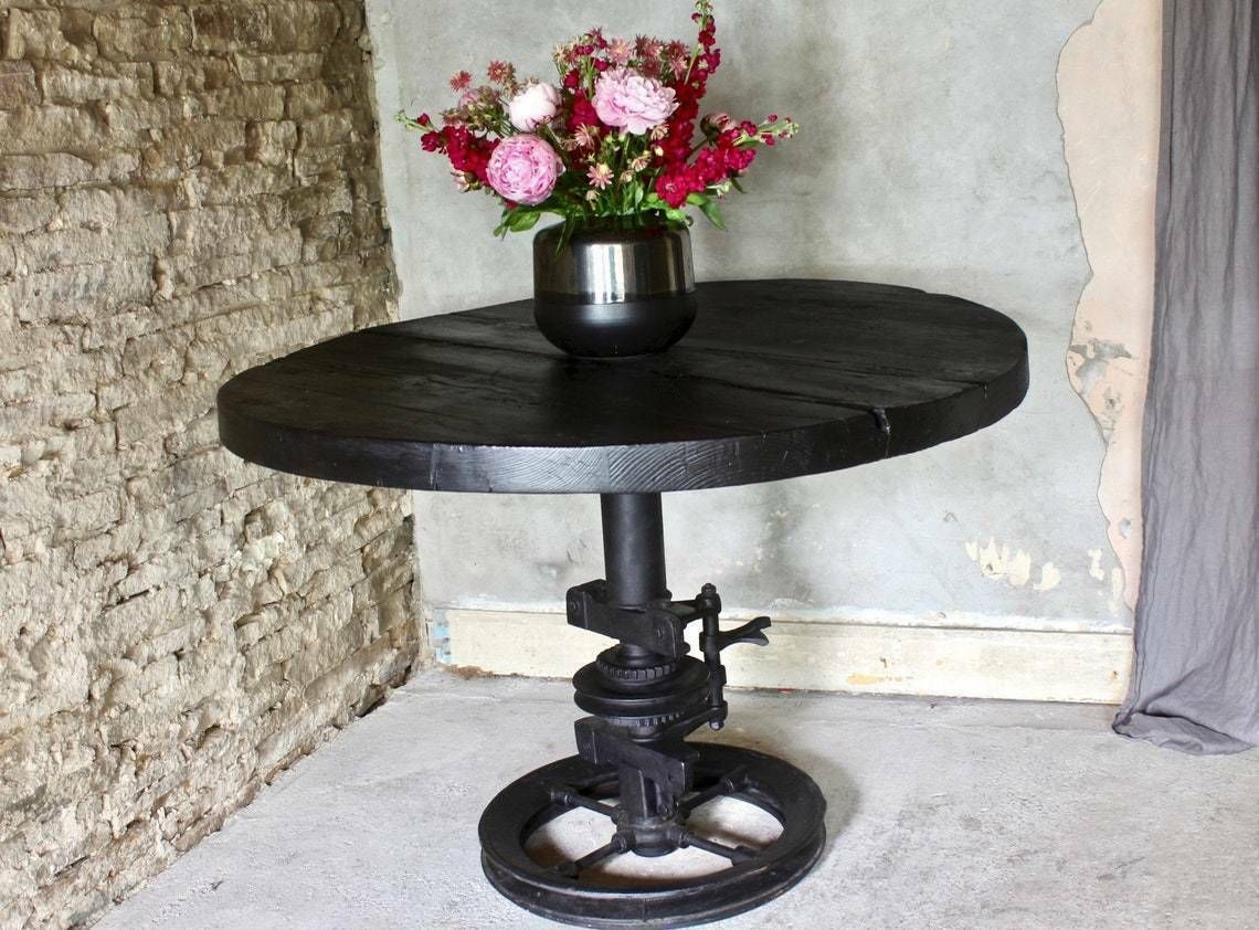 Shift Reclaimed Chunky Scorched Timber Circular Table With A Heavy Pedestal Base Made Out Of An Old Gear System photo vinterior