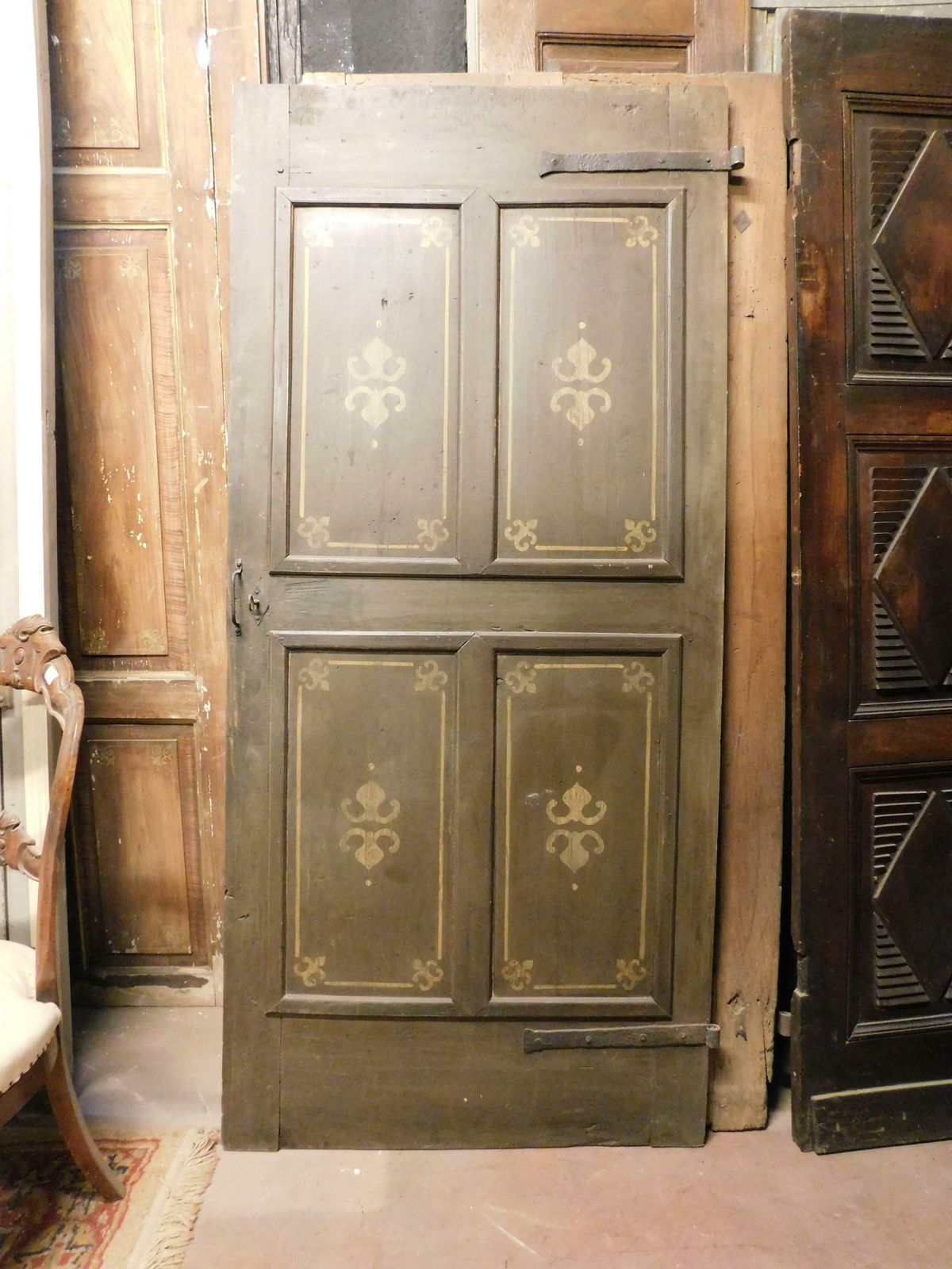 Old Door With 4 Painted Panels, Yellow Decorations On Green Background, Italy photo Home Fixtures