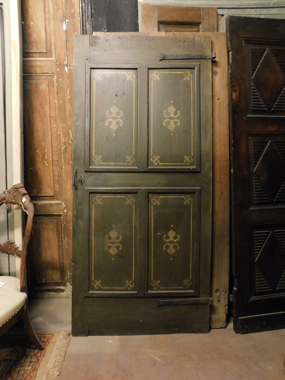 Old Door With 4 Painted Panels, Yellow Decorations On Green Background, Italy photo vinterior