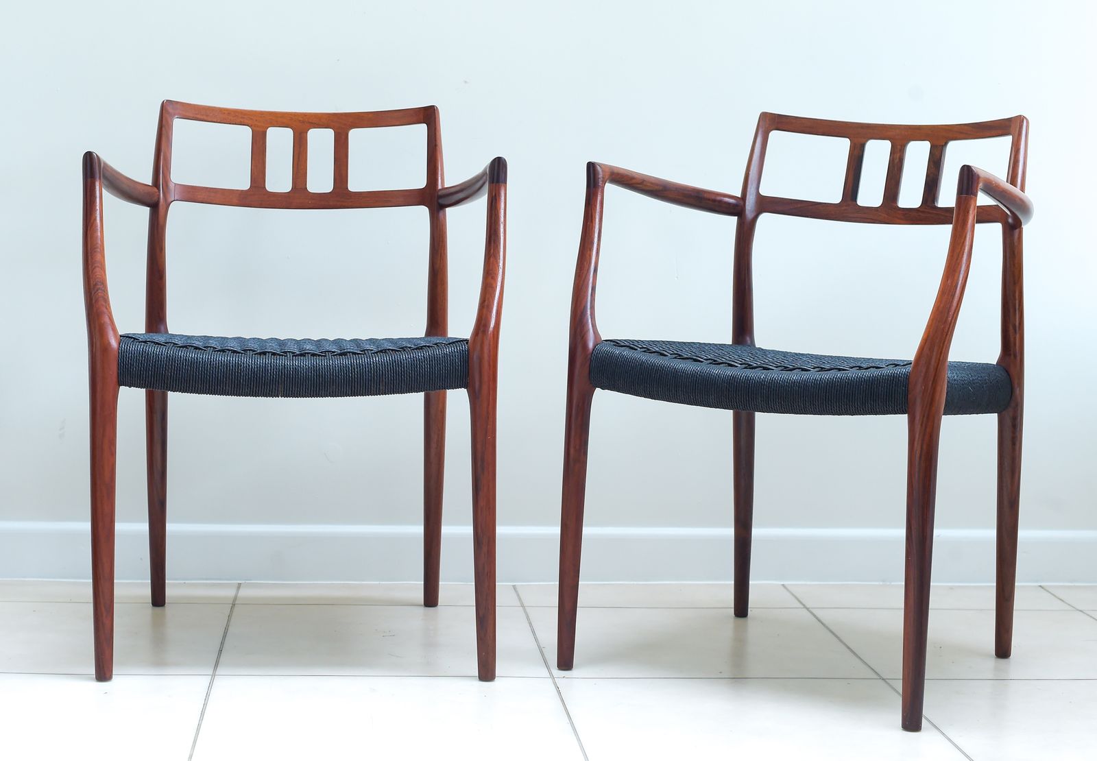 photo furniture A Scarce Pair Of Niels Møller Model 64 Rosewood Carver Chairs For J L Moller, Denmark.