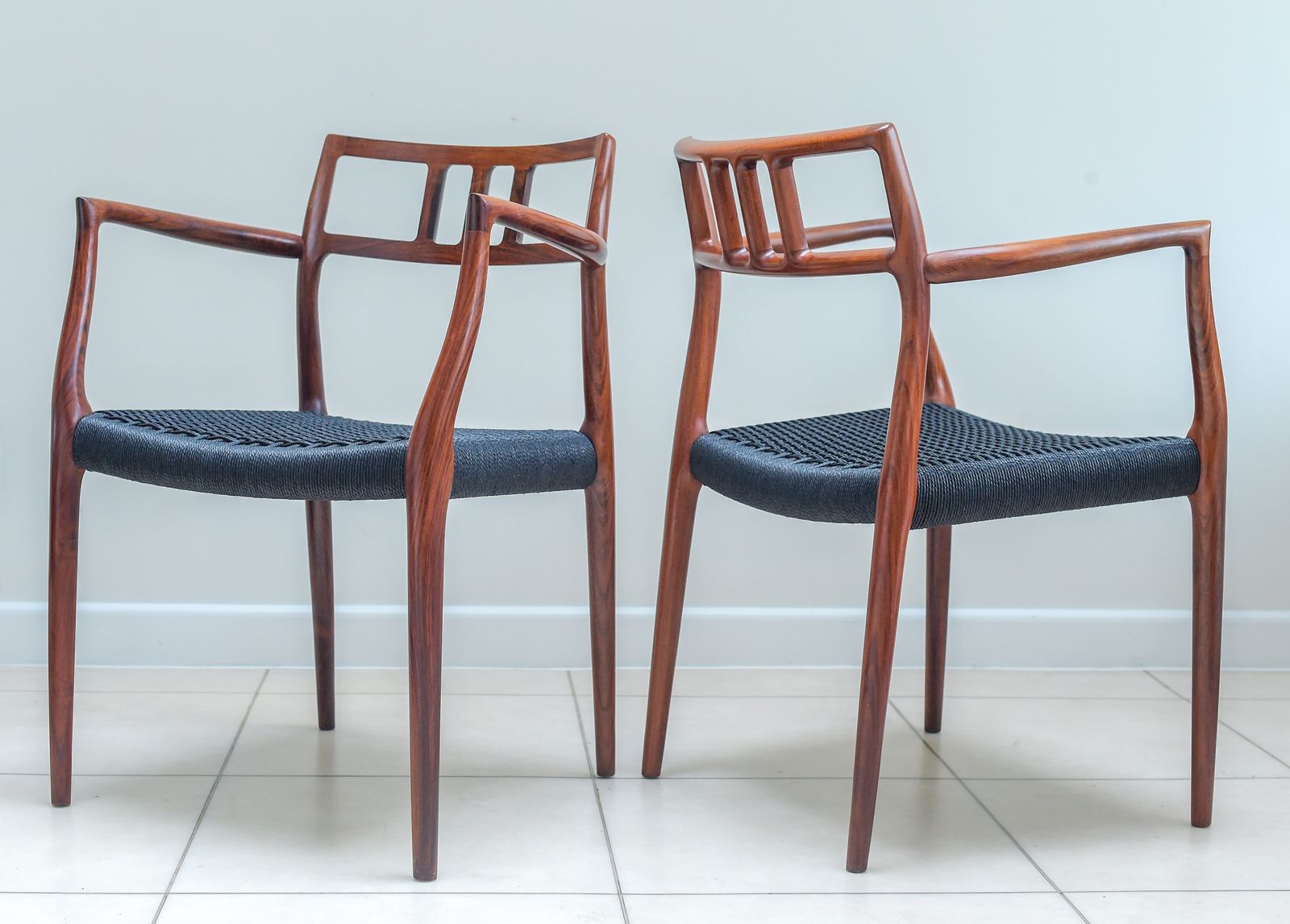 photo buy A Scarce Pair Of Niels Møller Model 64 Rosewood Carver Chairs For J L Moller, Denmark.