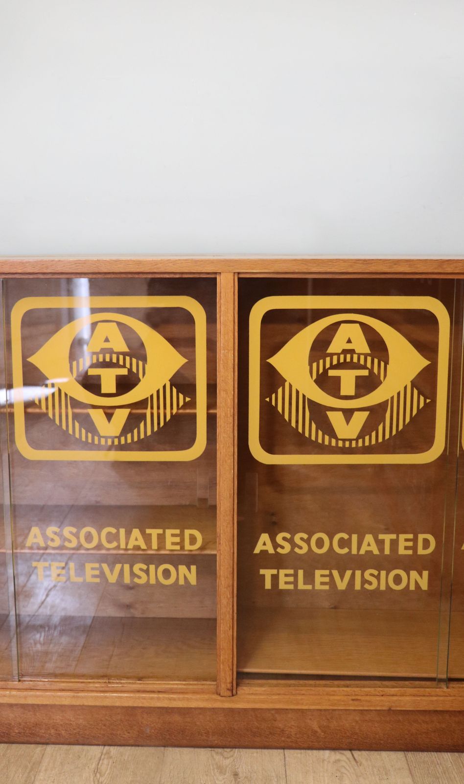 A Mid Century Oak Bookcase Cabinet, Later Sign Written For Associated Television. photo vinterior