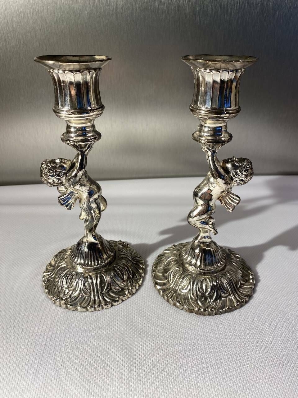 Two Silver Metal Candlesticks Decorated With 20th Century Cherubs photo furniture