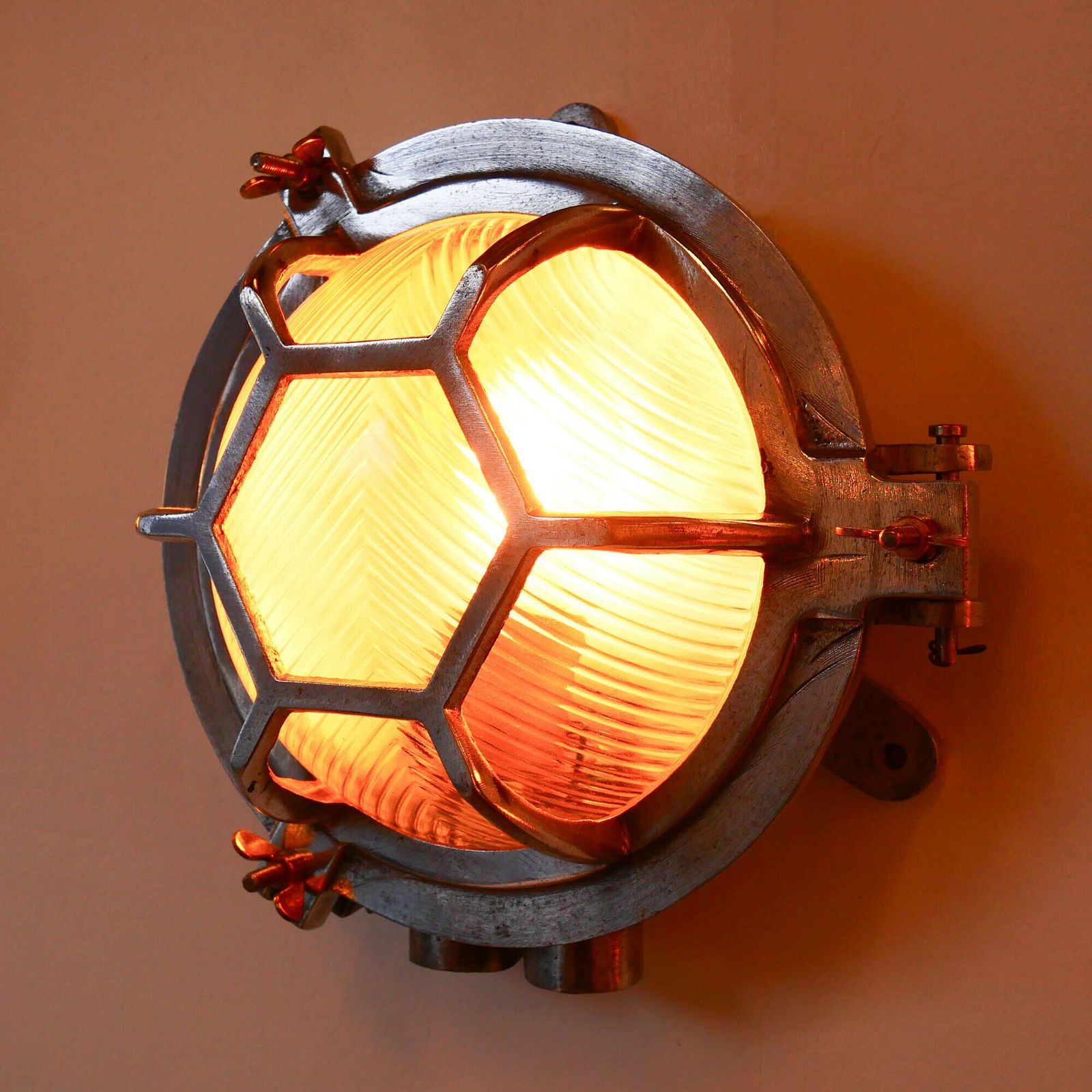 Old Cast Aluminum Wall Light With Hexagonal Grid And Wide Streaked Glass. photo Lighting