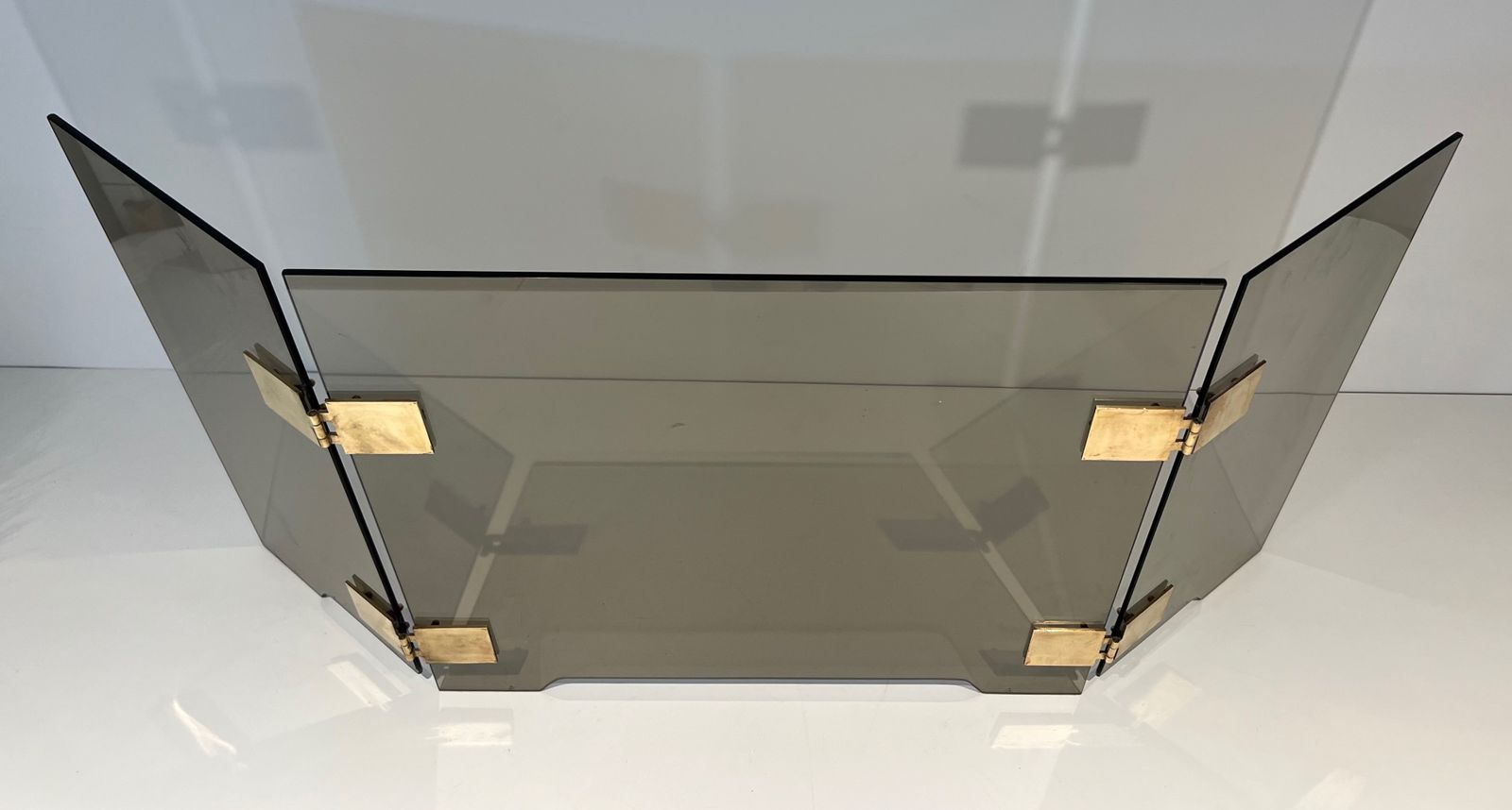 Tri Fold Firewall In Smoked Glass And Brass. Around 1970 photo for sale
