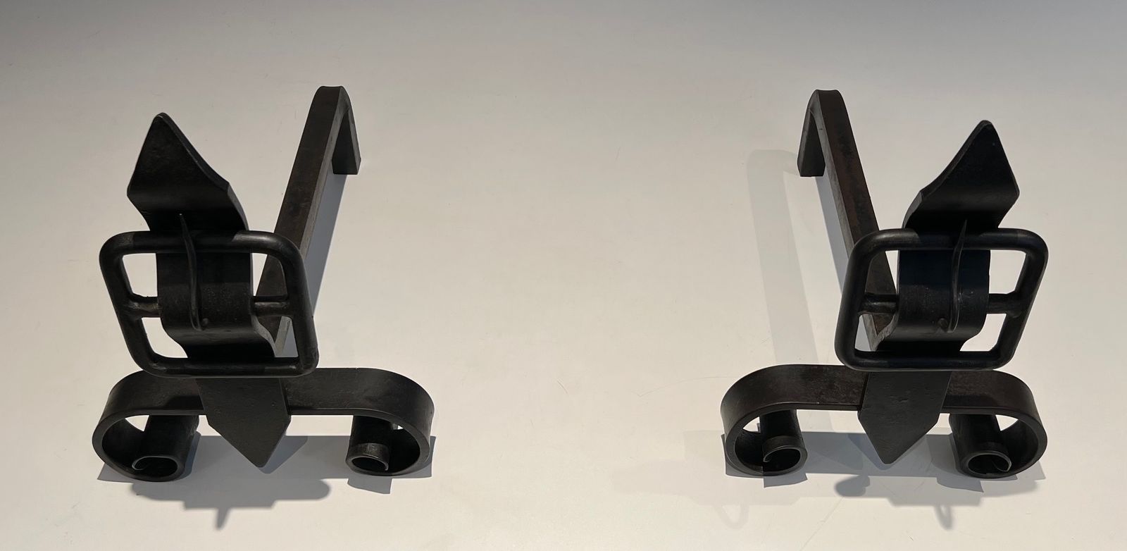 Pair Of Modernist Andirons Representing A Belt photo for sale