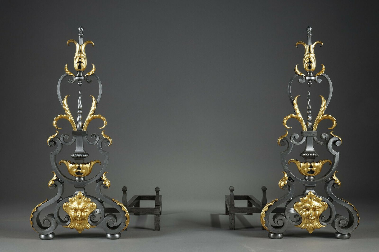 Pair Of Wrought Iron Landiers With Foliage, Mask And Scroll Decoration photo for sale