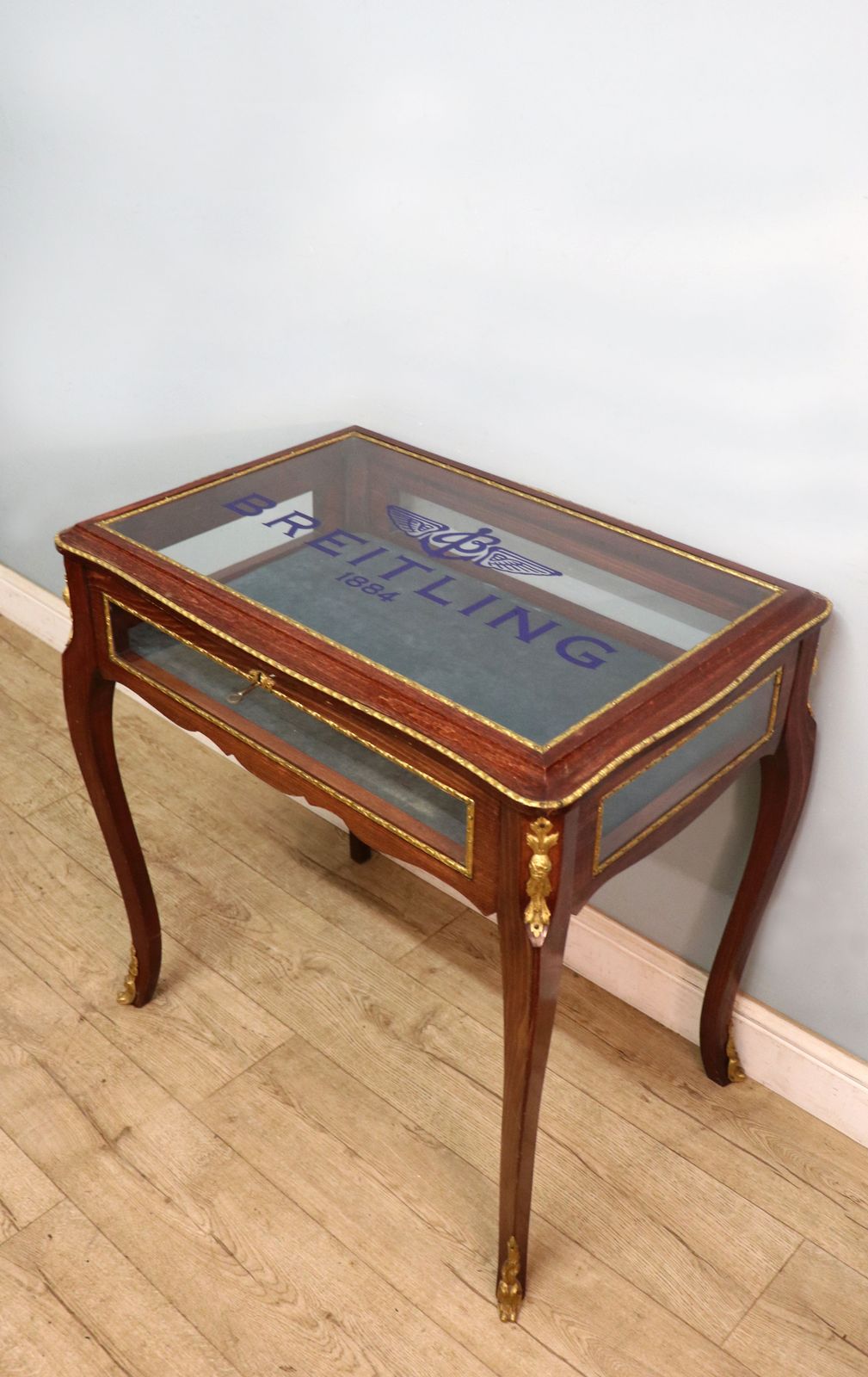 photo furniture A Lovely 20th Century French Hardwood Bijouterie Display Table Later Sign Written For Breitling Watches.