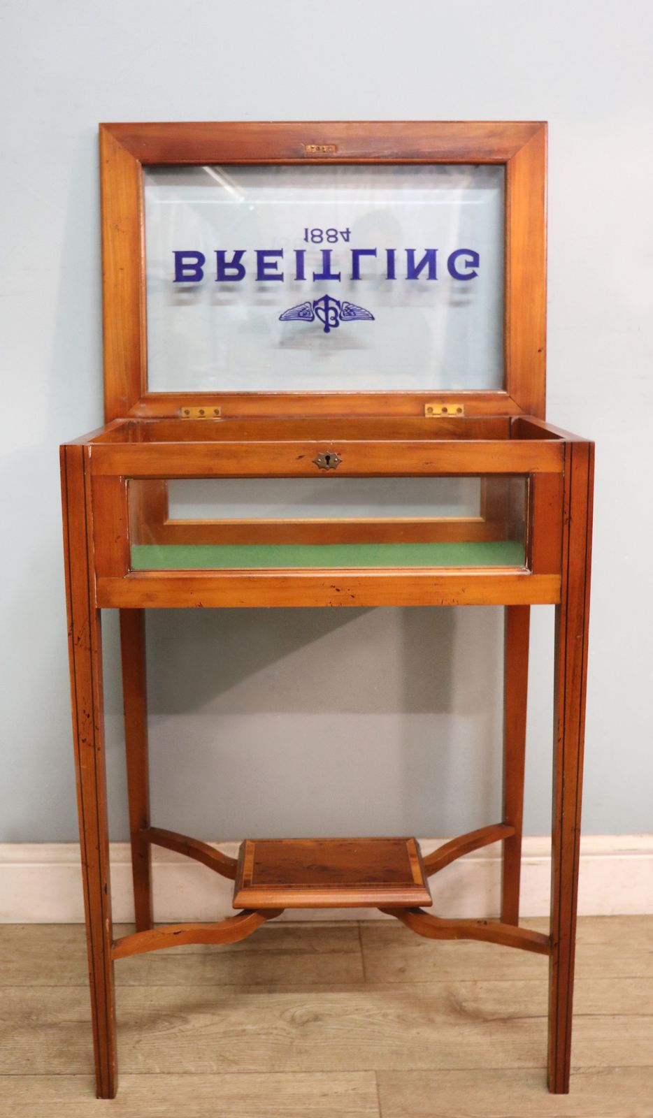 A Lovely Yew Wood Veneered Bijouterie Display Table, Later Sign Written For Breitling Watches. photo furniture