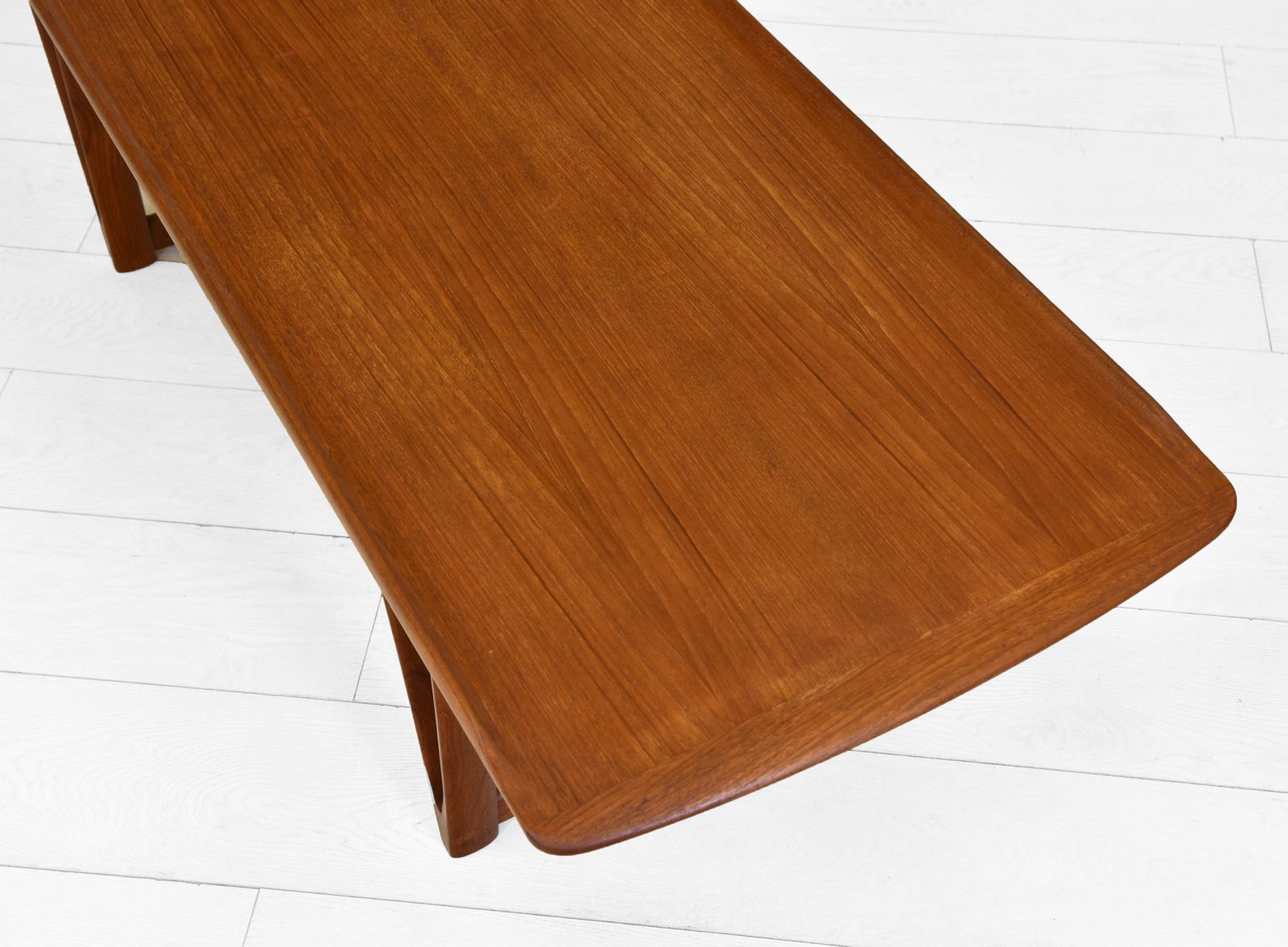 Mid Century Danish Teak Coffee Table On V Shape Supports And Lipped Top Edge photo vinterior