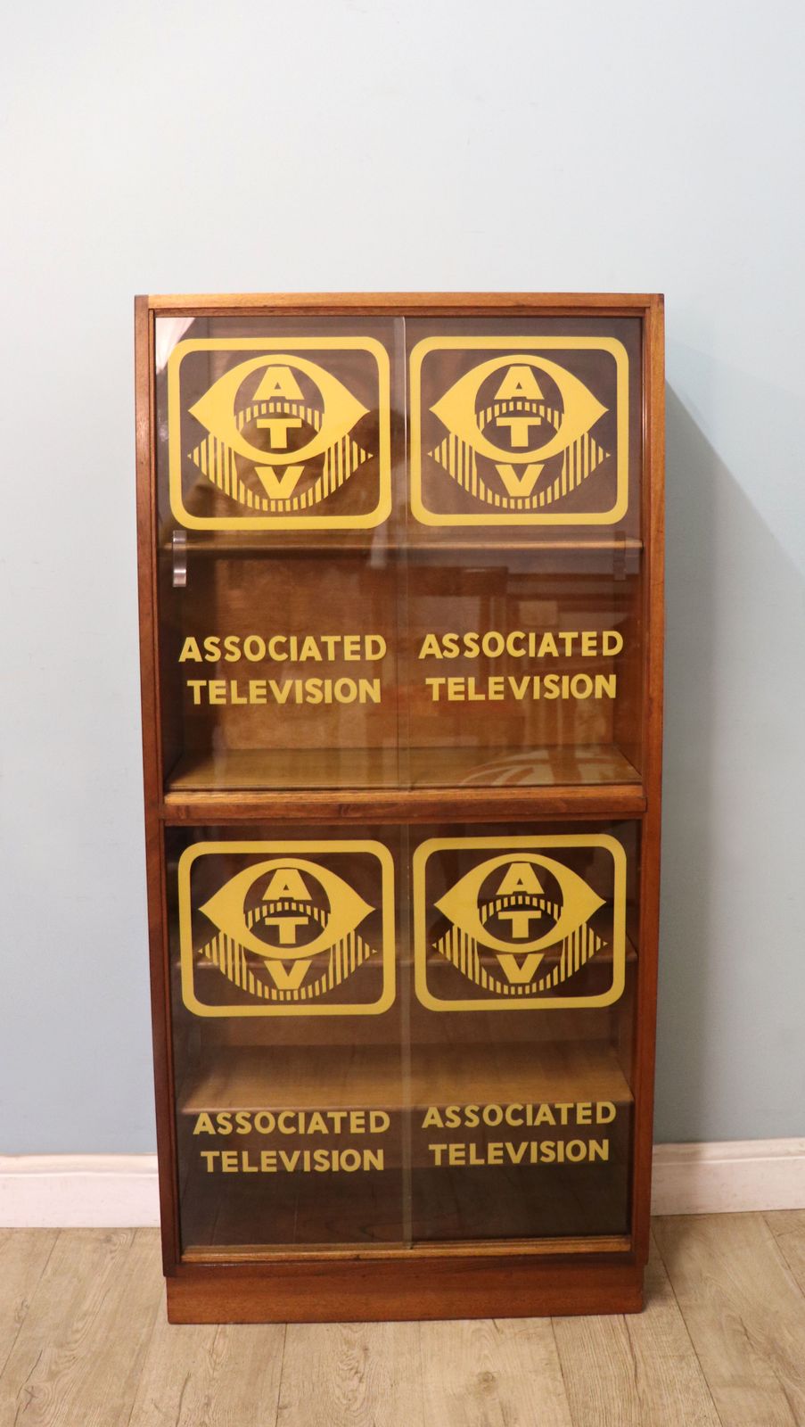 A Lovely Mid Century Display Cabinet Later Sign Written With The Emblems And Wording For Associated Television.