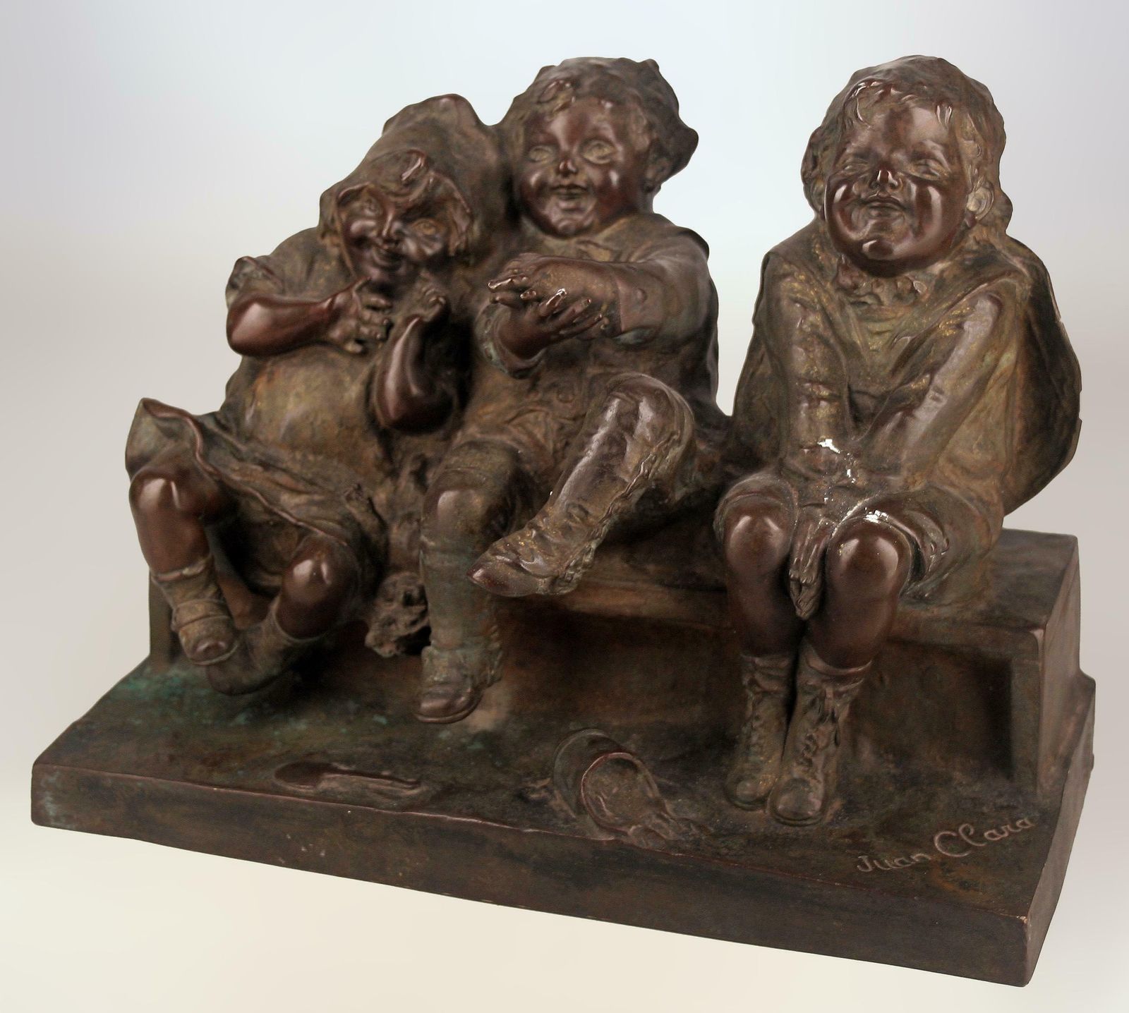 'Watching Something': Patinated Bronze Sculpture Of Three Children Laughing And Sitting By Spanish Artist Juan Clara photo furniture
