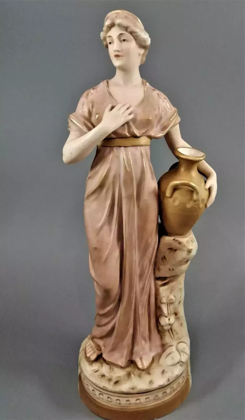 Beautiful Antique Royal Dux Porcelain Figurine Depicting A Lady Holding A Jug.