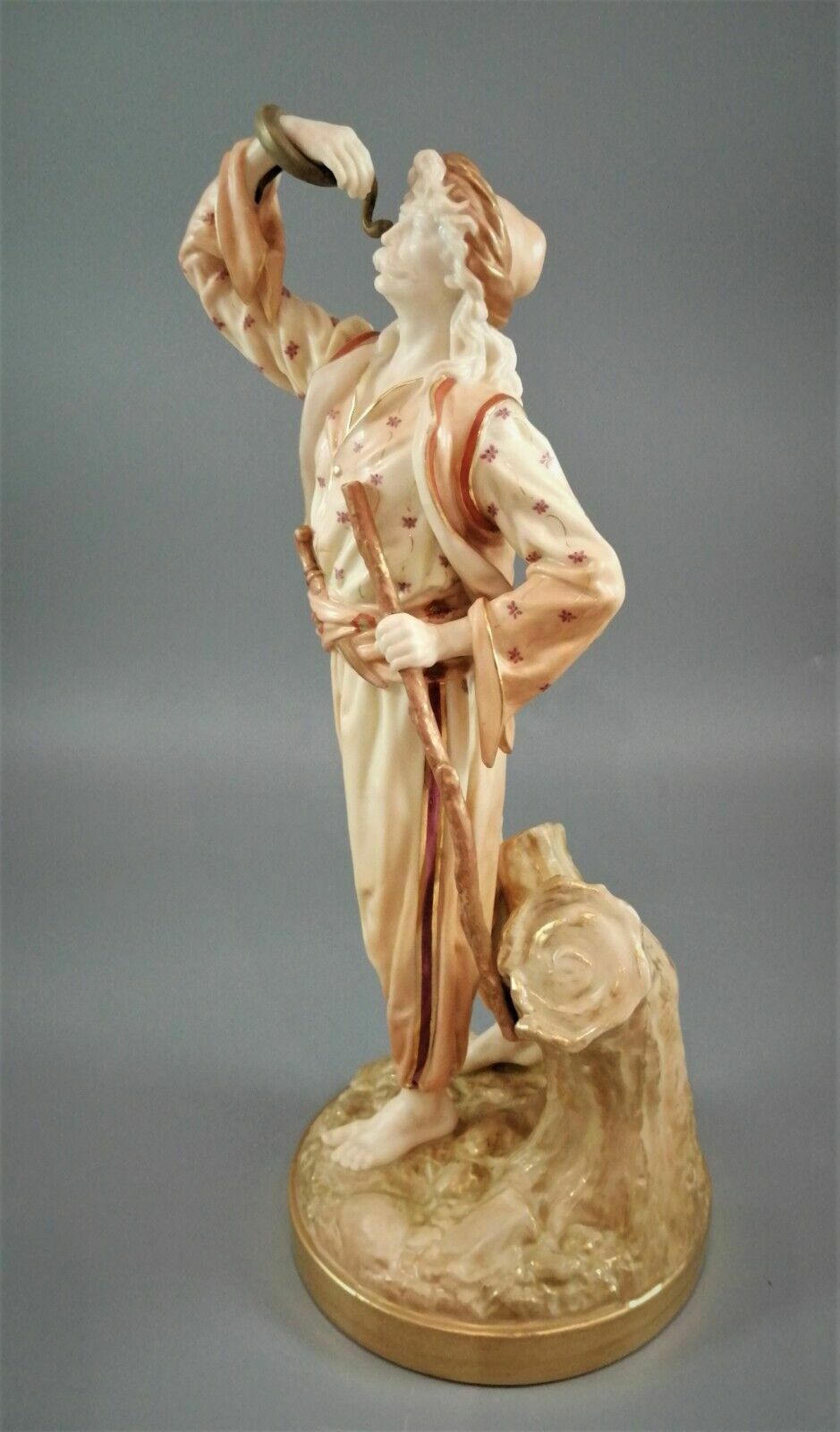A Rare Royal Worcester Figurine Titled "The Snake Charmer," Dated 1898. photo furniture