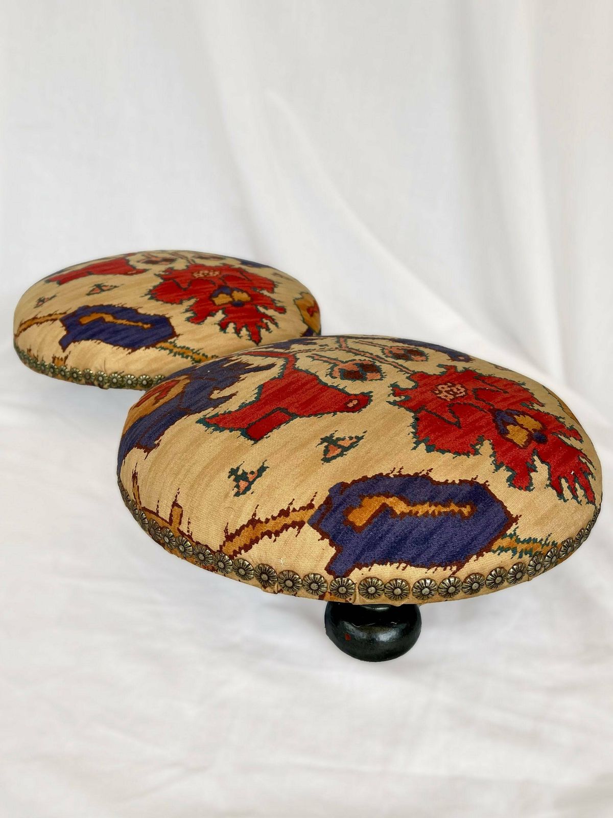 Antique French Style Foot Stools In Original Fabric With Floral Brass Flower Stud Detailing And Three Wooden Bun Feet To Base.