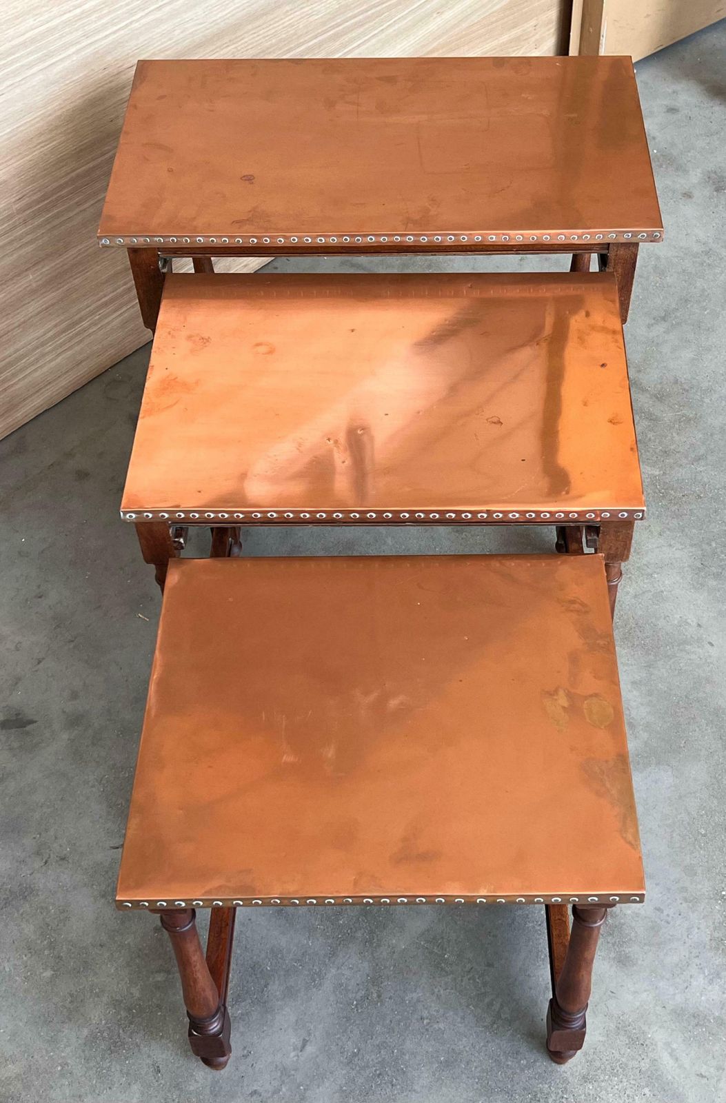 photo furniture Set Of Three Spanish Walnut Nesting Tables With Copper Top