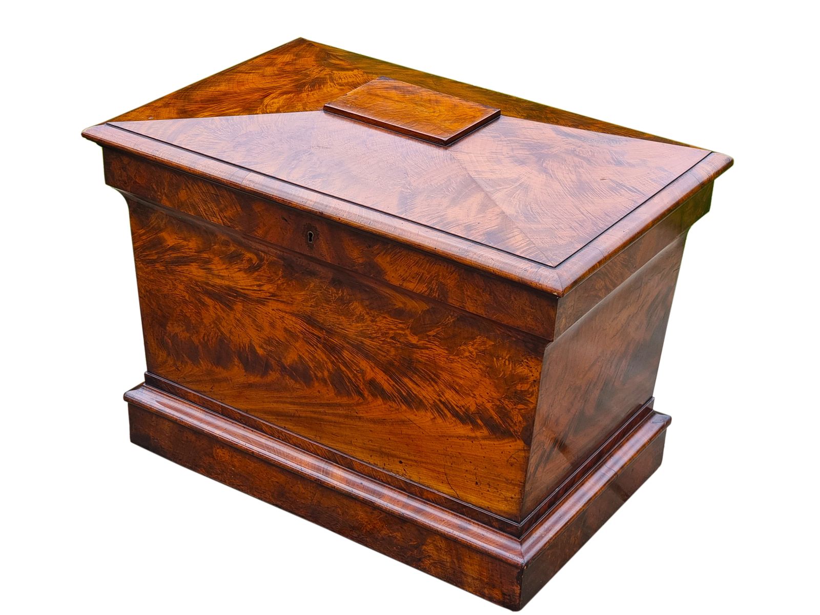 An English Regency Wine Cooler Sarcophagus Shaped And Superbly Veneered In Flame Mahogany, Circa 1820