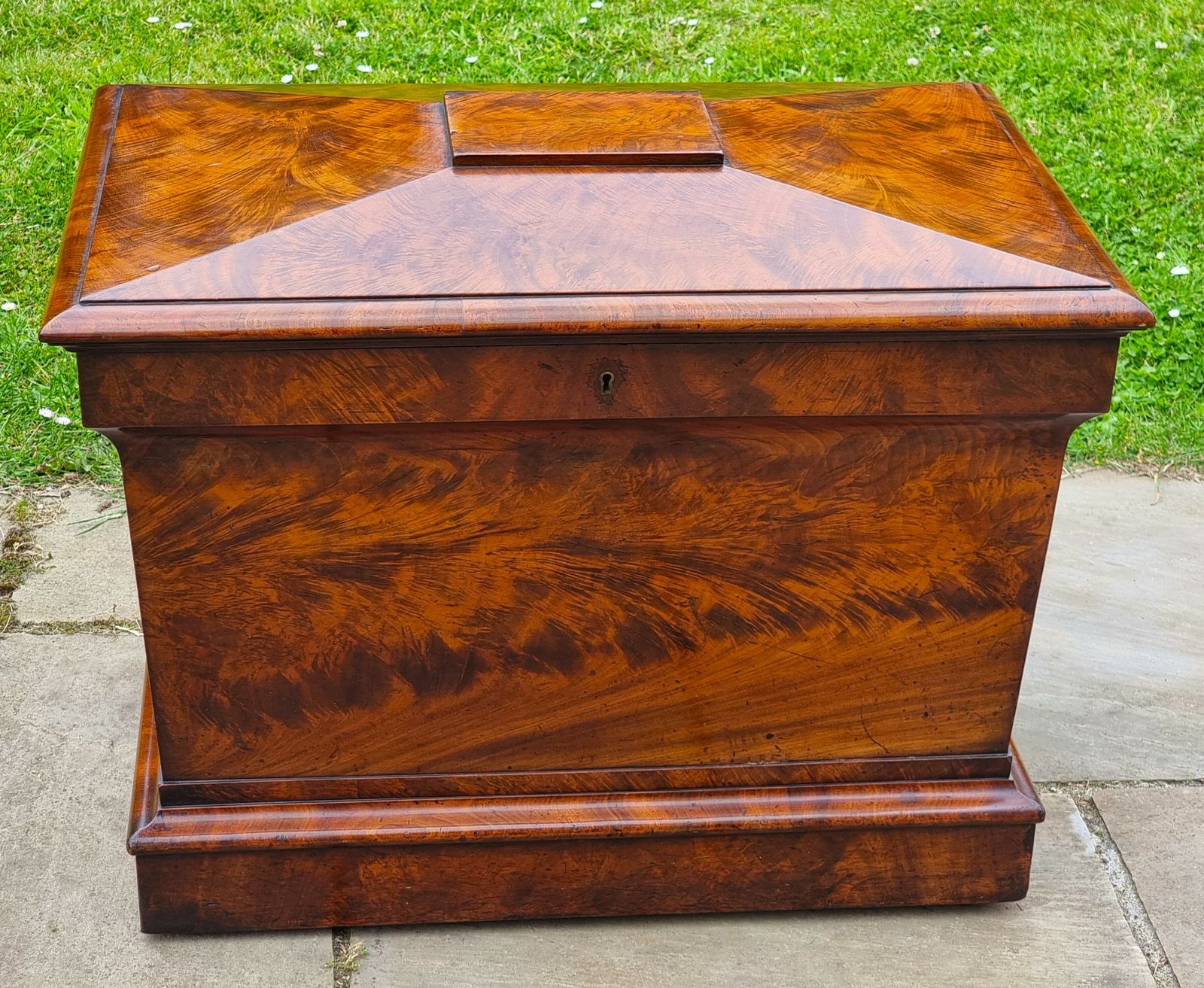 1895.0 An English Regency Wine Cooler Sarcophagus Shaped And Superbly Veneered In Flame Mahogany, Circa 1820 photo