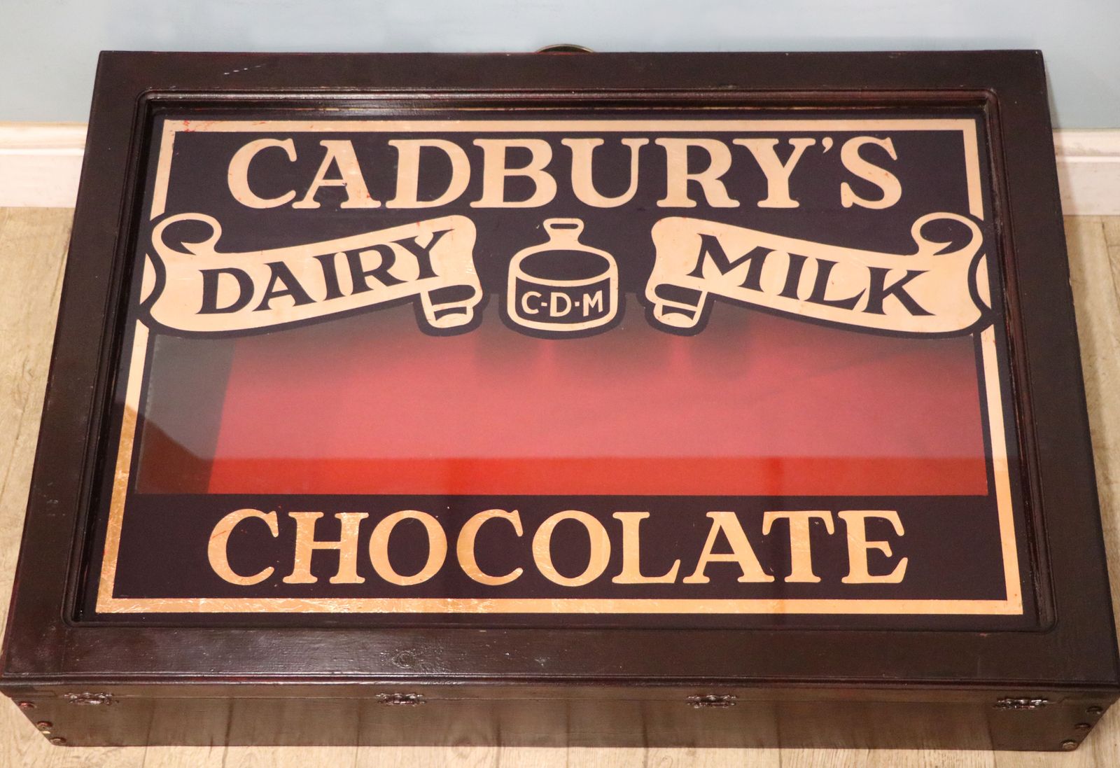 A Superb Wedge Shaped Countertop Display Cabinet, Later Hand Sign Written For Cadburys Dairy Milk Chocolate. photo Furniture