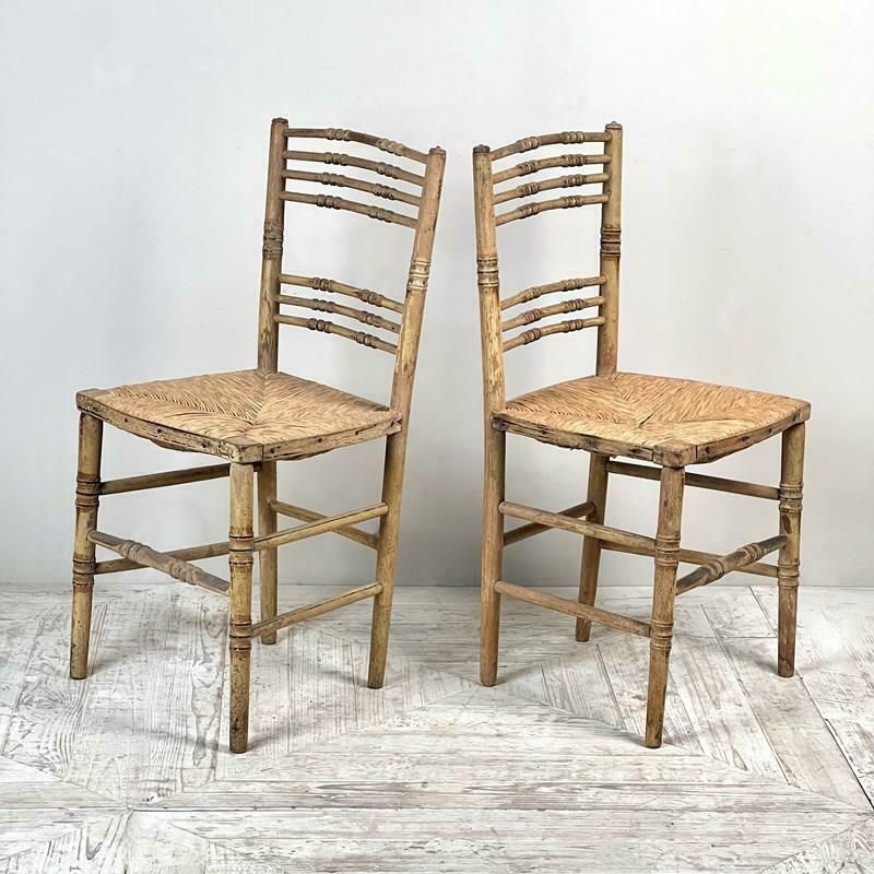 A Pair Of Painted Regency Faux Bamboo And Rush Seat Chairs photo furniture