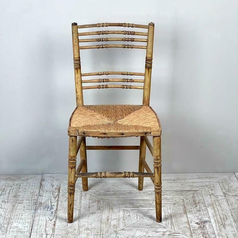 photo for sale A Pair Of Painted Regency Faux Bamboo And Rush Seat Chairs