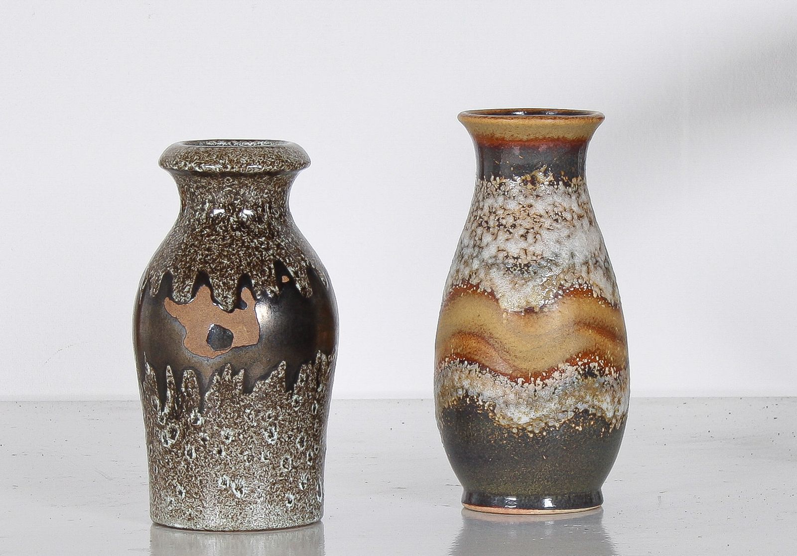 A Pair Of West German Pottery Lava Vases In Earthy Vibrant Tones