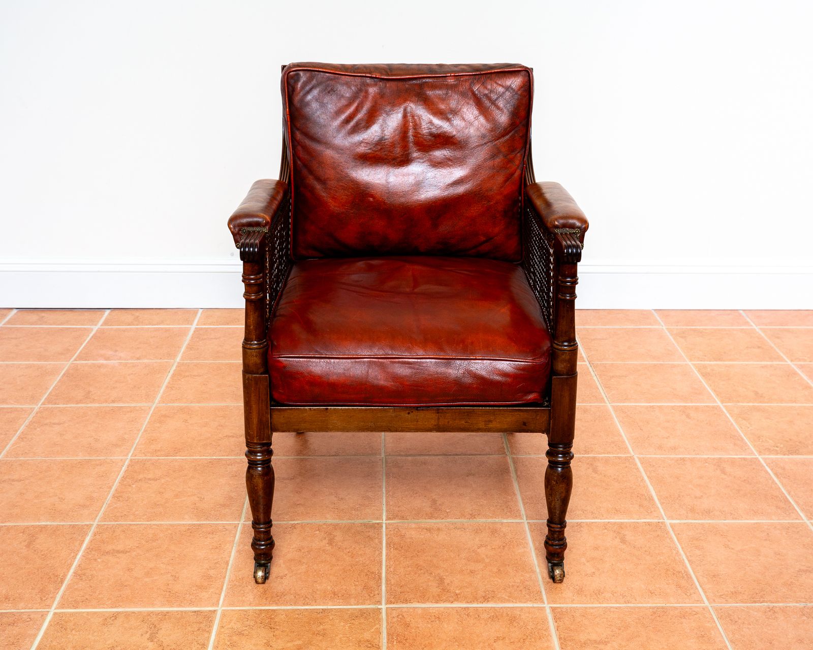 Fine Regency Bergere Leather Library Chair 1810 1820 Georgian Reading Red Leather Armchair Carved Cane Rattan Brass Castors photo vintage