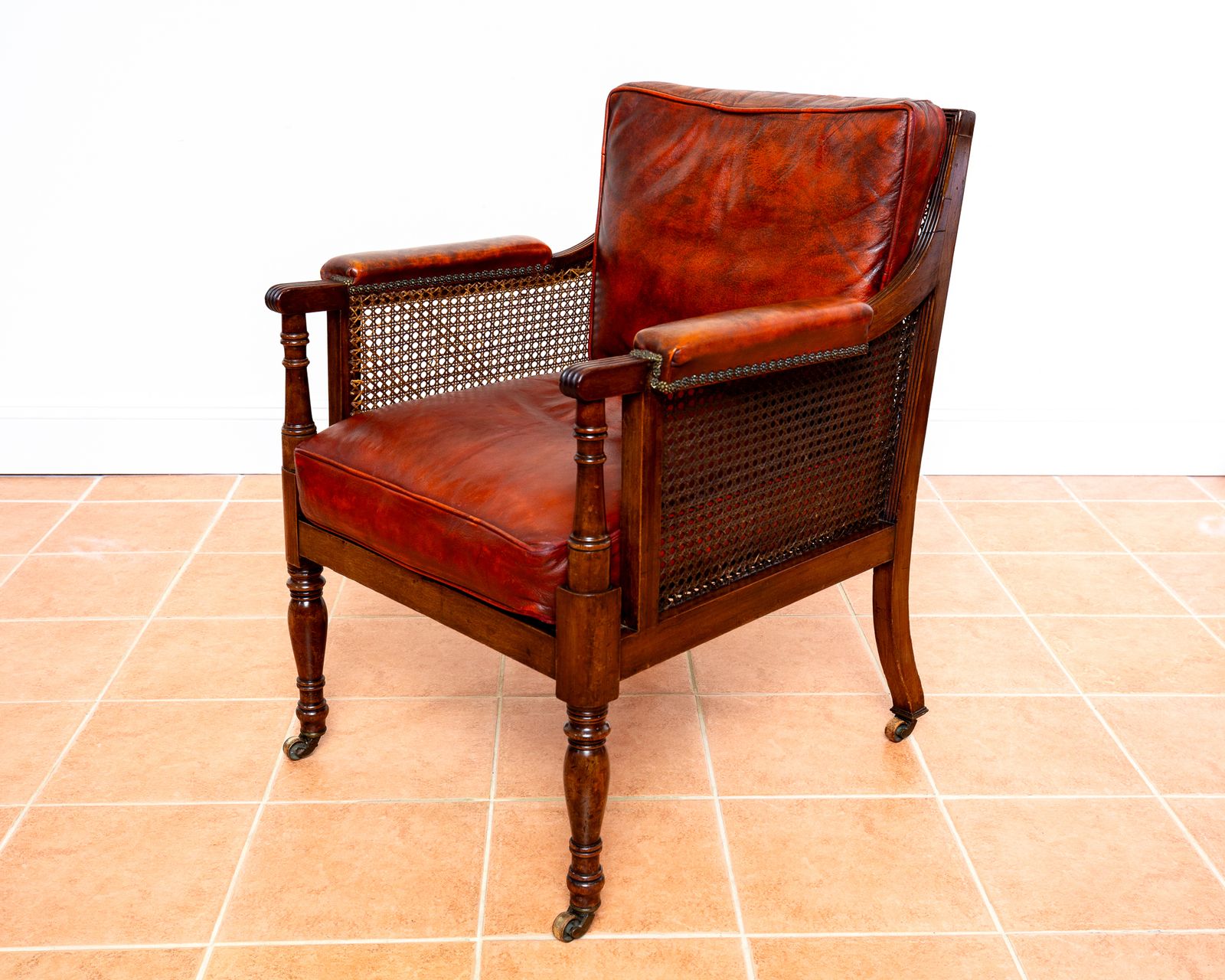 Fine Regency Bergere Leather Library Chair 1810 1820 Georgian Reading Red Leather Armchair Carved Cane Rattan Brass Castors photo buy
