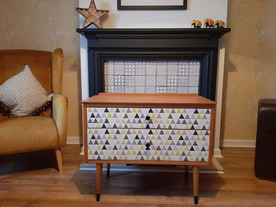 Mid Century Chest Of Drawers With Tapered Legs And Added Geometric Design.