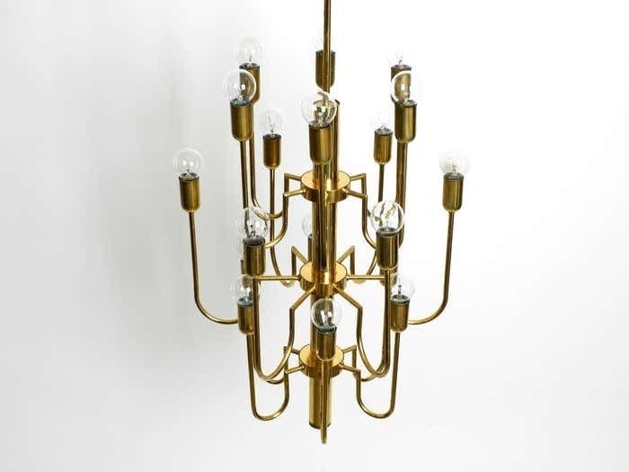 1876.0 Beautiful Three Staged 18 Arm Mid Century Brass Chandelier With A Long Brass Rod photo