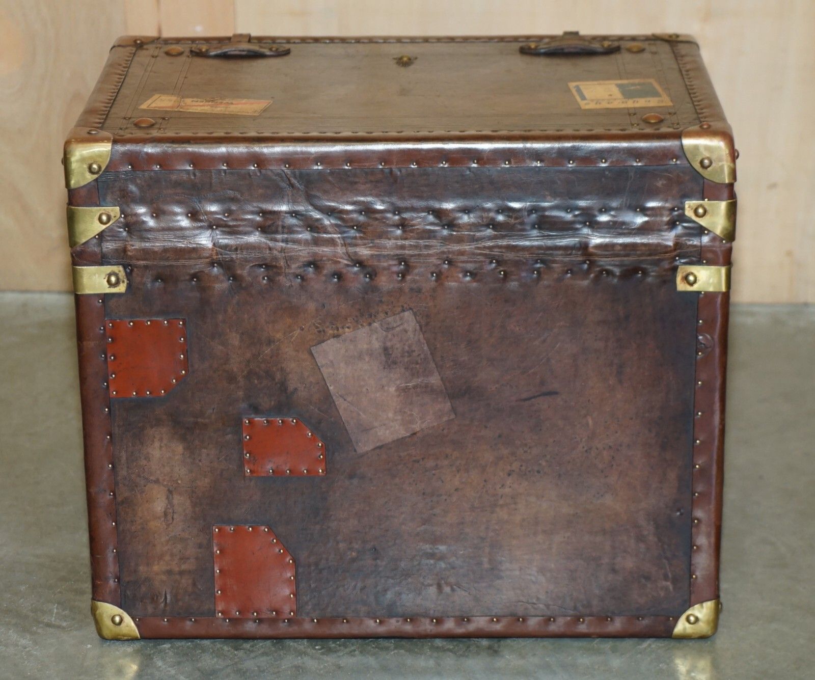 photo furniture Pair Of Armorial Coat Of Arms Vintage Brown Leather Steamer Trunk Side Tables