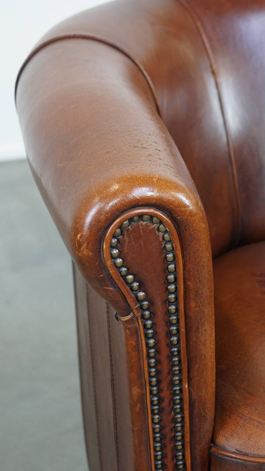 photo furniture Sheepskin Club Chair In A Charming Cognac Colour And Finished With Piping On The Backrest