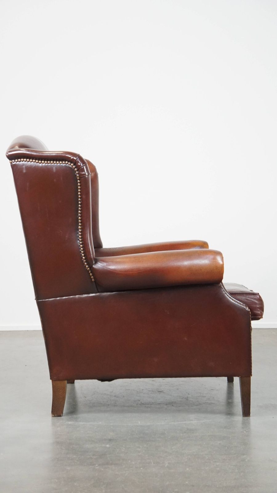 Classic, Luxurious And Comfortable Dark English Style Sheepskin Wing Chair With Lots Of Character And A Beautiful Patina photo for sale