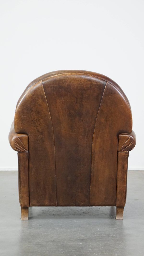 Classic, Dark, Good Condition Sheepskin Armchair With Beautiful Round Shapes And On Wheels photo for sale