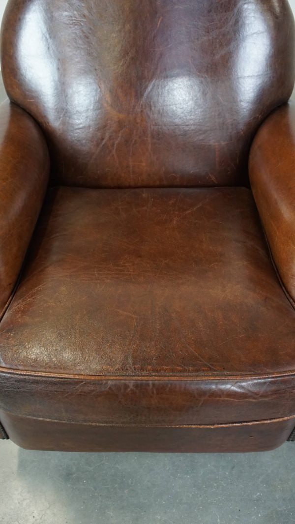 Classic, Dark, Good Condition Sheepskin Armchair With Beautiful Round Shapes And On Wheels photo 1016.1353999999999