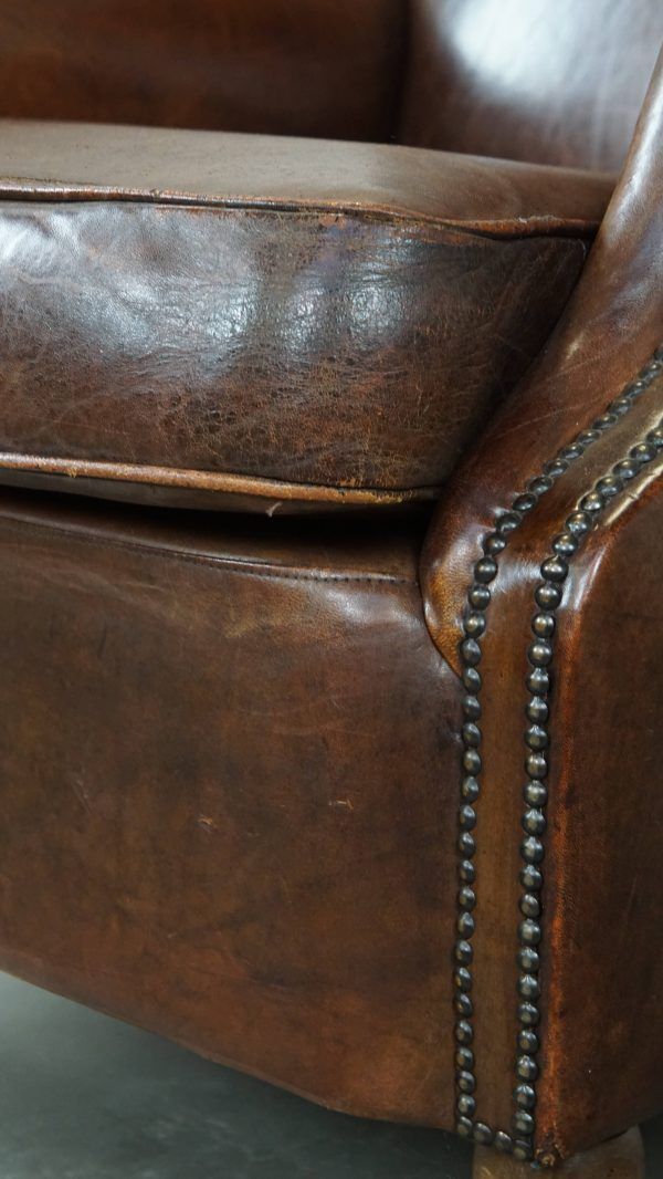 photo for sale Klassieke Schapenvacht Fauteuil In Donkere Kleur, Goede Staat, Met Ronde Vormen En Op Wieltjes