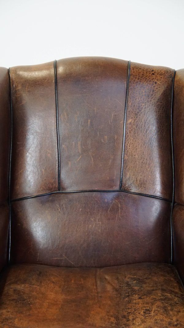 photo furniture Characteristic And Comfortable Sheepskin Wing Chair With A Beautiful Patina