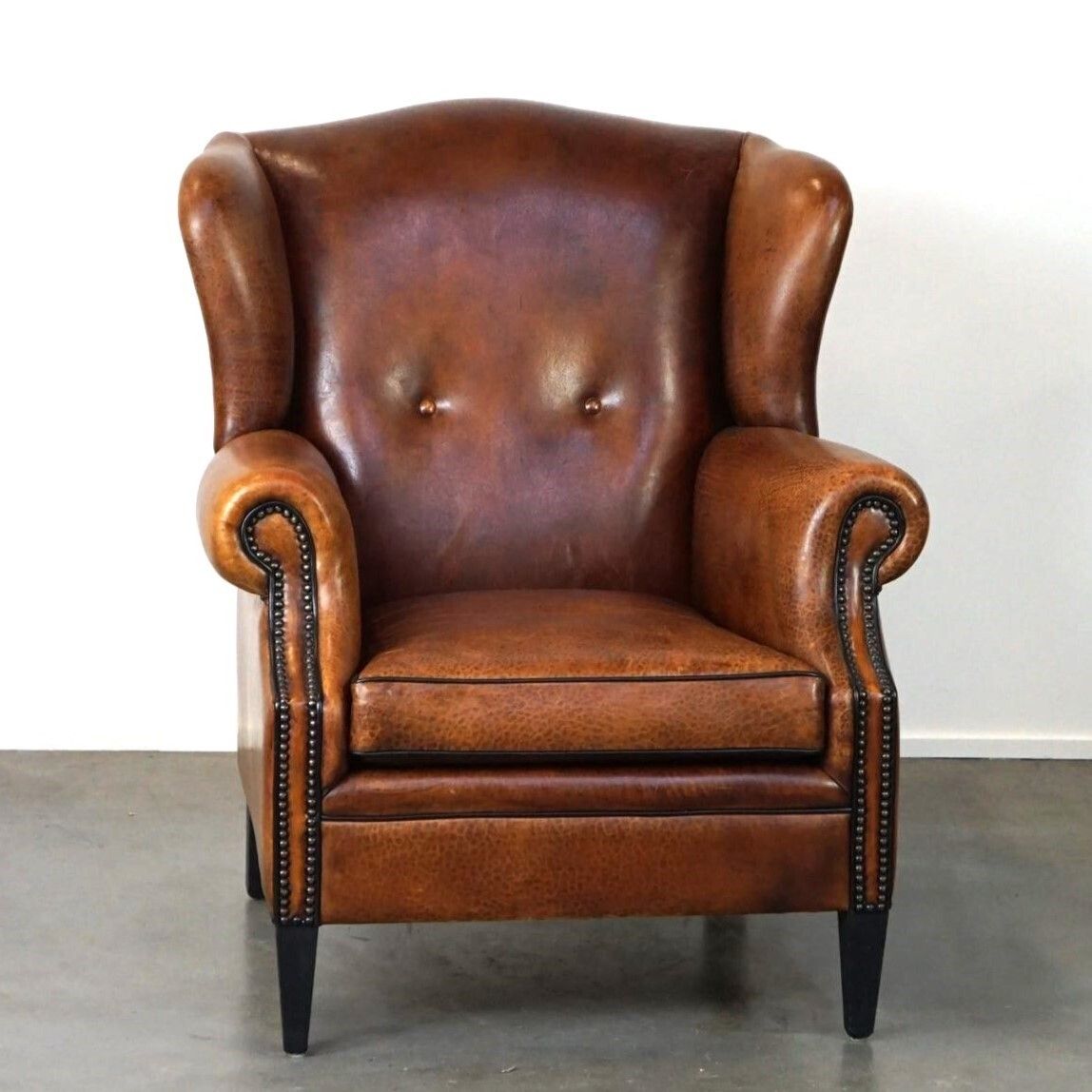 Beautiful Armchair Made Of Very Good Quality Sheepskin Finished With Nails And Black Piping photo furniture