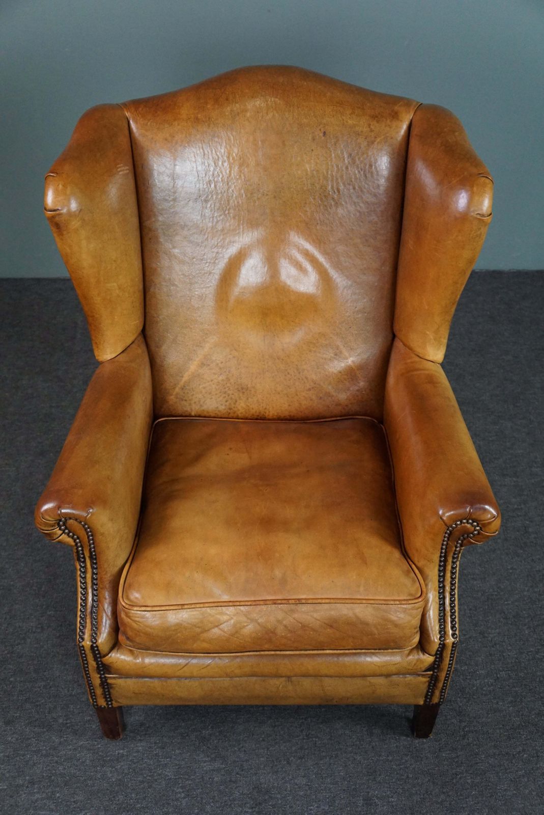 Expressive Cognac Colored Sheepskin Wing Chair photo vinterior