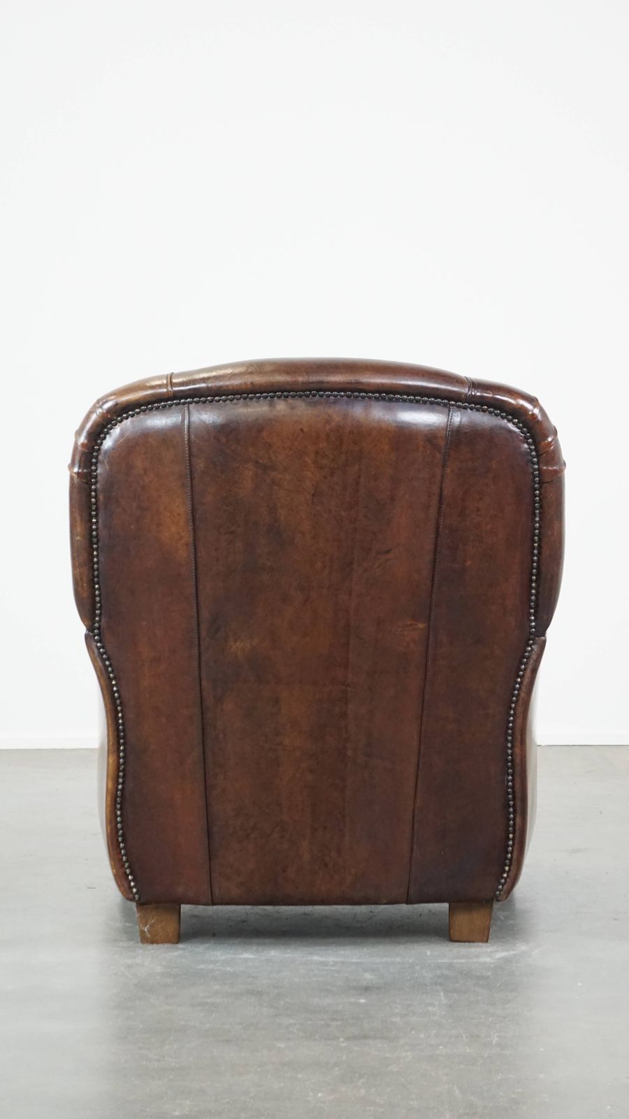 Royal And In Good Condition Dark Sheepskin Armchair With Round Shapes And A Comfortable Seat photo Furniture